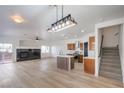 Bright living room boasts fireplace, stylish light fixture, and an island connected to kitchen at 8798 Tom Noon Ave # 103, Las Vegas, NV 89178