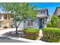 Inviting two-story home with mature landscaping and a charming front porch at 9408 Ironsend St, Las Vegas, NV 89143
