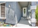 Close-up of the front entrance showcasing the textured walls and tiled columns at 9408 Ironsend St, Las Vegas, NV 89143