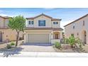 Two-story home with a two-car garage, low-maintenance landscaping, and a neutral color palette at 953 Via Del Tramonto St, Henderson, NV 89011
