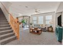 Open-concept living room featuring a staircase, plush carpeting, and abundant natural light at 953 Via Del Tramonto St, Henderson, NV 89011
