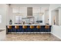 Open concept kitchen with a large island, pendant lighting, and modern bar stools at , Las Vegas, NV 89149