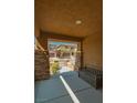 Welcoming front porch featuring stone columns and a bench, offering a cozy outdoor seating area at 10404 Mystic Pine Rd, Las Vegas, NV 89135