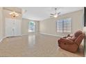 Bright living room with neutral walls, tile flooring, and large windows at 10673 Bonchester Hill St, Las Vegas, NV 89141