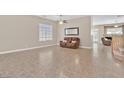 Comfortable living room with tile flooring and a view of the staircase at 10673 Bonchester Hill St, Las Vegas, NV 89141
