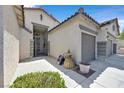Home entrance features a gated courtyard, two-car garage, and upgraded landscaping at 10701 Morning Harbor Ave, Las Vegas, NV 89129