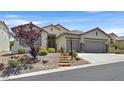 Charming home features a low maintenance front yard and a two-car garage at 10701 Morning Harbor Ave, Las Vegas, NV 89129