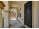 Covered entry featuring an arched doorway and a dark-colored, paneled front door at 10804 Mason Hill Ave, Las Vegas, NV 89166