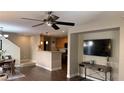Open concept living room with hardwood floors, a ceiling fan, and a TV at 10804 Mason Hill Ave, Las Vegas, NV 89166