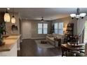 Bright living room with hardwood floors, a sofa, and large windows at 10804 Mason Hill Ave, Las Vegas, NV 89166