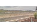 Backyard desert landscape view with mountains and cloudy sky at 1135 Paradise Mountain Trl, Henderson, NV 89002