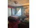 A view of the bedroom with a queen bed, patterned bedding, and neutral toned carpet at 1507 Elizabeth Ave # 1, Las Vegas, NV 89119