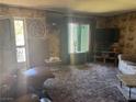 The living room has patterned walls, a large window and two televisions at 1507 Elizabeth Ave # 1, Las Vegas, NV 89119
