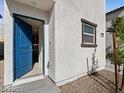 Entryway with a blue front door and a small window at 1891 Via Del Prado St, Las Vegas, NV 89115