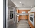 Modern kitchen with stainless steel appliances, granite countertops, and light wood cabinetry at 23 E Agate Ave # 308, Las Vegas, NV 89123