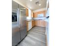 Well-lit kitchen featuring stainless steel appliances, granite countertops, and light wood cabinets at 23 E Agate Ave # 308, Las Vegas, NV 89123