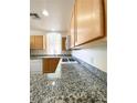 Spacious kitchen with granite countertops, stainless sink, and white appliances is move-in ready at 23 E Agate Ave # 308, Las Vegas, NV 89123