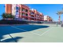 View of a community tennis court with adjacent condo buildings in the background on a sunny day at 23 E Agate Ave # 308, Las Vegas, NV 89123
