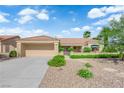 Front exterior features a two-car garage, terra cotta roof, and well-maintained desert landscaping at 2825 Brianwood Ct, Las Vegas, NV 89134