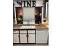 Cozy kitchen area featuring a sink, dishwasher, and playful wine-themed curtains, adding a touch of personality at 3128 Spring City Ave, North Las Vegas, NV 89081
