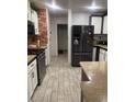 Galley-style kitchen with stainless steel appliances, granite countertops, and white cabinets at 3128 Spring City Ave, North Las Vegas, NV 89081