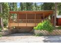 Cozy cabin exterior with a covered deck, showcasing the property's unique architectural details at 4581 Aspen Ave, Mount Charleston, NV 89124