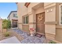 Inviting home entrance with decorative wreath, flower pot, and brick pathway at 4725 Blaise Ave # 103, North Las Vegas, NV 89084