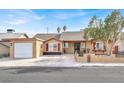 Charming single-story home featuring a well-manicured front yard, shutters, and an attached one-car garage at 5005 Harmony Ave, Las Vegas, NV 89107