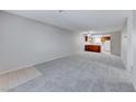 A view of a spacious living room with new carpet flowing seamlessly into an adjacent kitchen at 5199 Caliente St # 63, Las Vegas, NV 89119