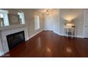 Bright living room featuring a fireplace, hardwood floors, and neutral paint at 5824 Red Gull St, Las Vegas, NV 89149