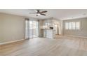 Bright living room area features wood-look floors and access to kitchen and exterior balcony at 7300 Pirates Cove Rd # 1032, Las Vegas, NV 89145