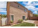The backyard features a patio area with artificial turf, partially enclosed with a privacy fence at 9031 Jumping Jacks Ave, Las Vegas, NV 89178