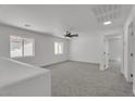 Upstairs bonus room with carpet and natural light from two windows at 9047 Harbor Wind Ave, Las Vegas, NV 89178