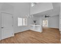 Spacious living room with wood floors, chandelier, and lots of natural light at 9047 Harbor Wind Ave, Las Vegas, NV 89178