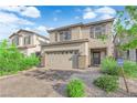 Attractive home featuring a two-car garage, brick paved driveway, and landscaped front yard at 1017 Huckburn Ave, Henderson, NV 89015