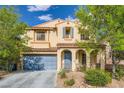 Lovely two-story home featuring desert landscaping and a covered entry with decorative arches at 10428 Mulvaney Cir, Las Vegas, NV 89141