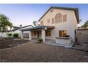 Expansive backyard featuring a covered patio, built-in bar, and easy to maintain landscape at 1206 Evening Canyon Ave, Henderson, NV 89014