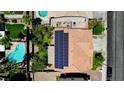 Aerial view of home with solar panels, red tile roof, landscaping, and private pool at 1371 Cumulus Ct, Henderson, NV 89014