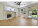 Bright living room featuring a fireplace, wood floors, and sliding glass doors for easy outdoor access at 1371 Cumulus Ct, Henderson, NV 89014