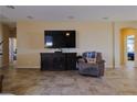 Open living area with tile floors and a large TV; great for entertainment and comfortable living at 2079 Port Royal Dr, Laughlin, NV 89029