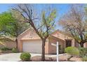 Charming single-story home featuring a well-maintained yard, mature trees, and an attached two-car garage at 2154 Eagle Sticks Dr, Henderson, NV 89012