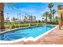 Stunning pool area with palm trees and manicured landscaping, perfect for outdoor enjoyment at 2200 Glenbrook Way, Las Vegas, NV 89117