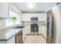 Bright kitchen featuring stainless steel appliances, modern cabinetry, and a window with natural light at 2229 Bowstring Dr, Las Vegas, NV 89142