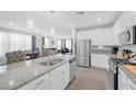 Modern open-concept kitchen with granite countertops, stainless steel appliances, and pendant lighting at 2404 Elmont Ave, North Las Vegas, NV 89086