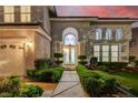 Charming front entrance with manicured hedges leading to the beautiful double doors of this home at 2496 Ram Crossing Way, Henderson, NV 89074