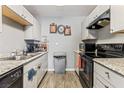Well-maintained kitchen with white cabinets, granite counters, and modern appliances at 2915 Cedar Ave # 11C, Las Vegas, NV 89101