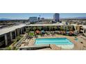 Resort-style pool area with lounge chairs, cabanas, and lush landscaping for relaxation at 353 E Bonneville Ave # 449, Las Vegas, NV 89101