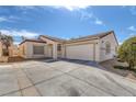 Home exterior featuring a two-car garage, stucco walls, and tile roof at 4828 Marco Polo St, North Las Vegas, NV 89031
