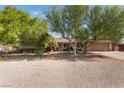 Charming single-story home with mature trees and desert landscaping in the front yard at 4905 Ricky Rd, Las Vegas, NV 89130