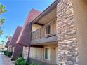 Exterior view of a two-story condo building showing stacked stone and balconies at 5020 Indian River Dr # 432, Las Vegas, NV 89103